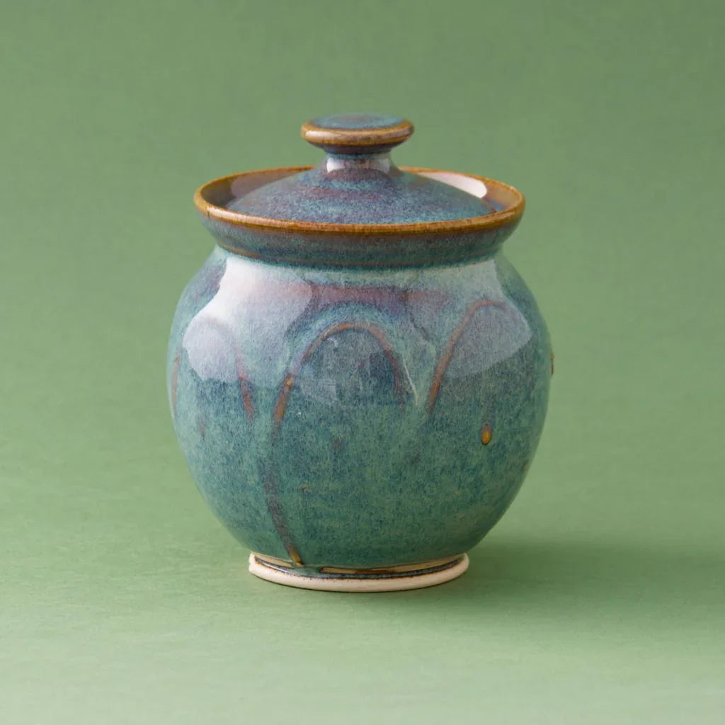 Handcrafted blue-green glazed pottery jar with lid, showcasing traditional Kilkenny ceramic artistry