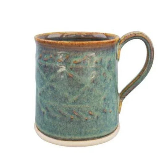 Handcrafted green ceramic pottery mug with textured surface and brown rim from Kilkenny's castlearchpottery