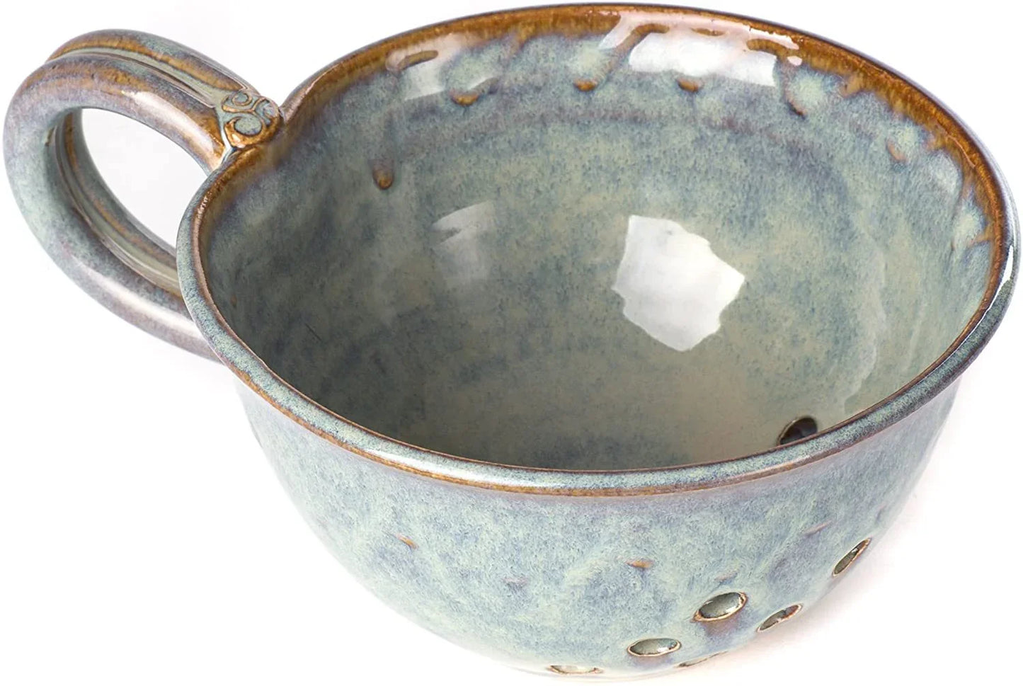 Handcrafted Kilkenny pottery blue ceramic mug with textured glaze and decorative holes