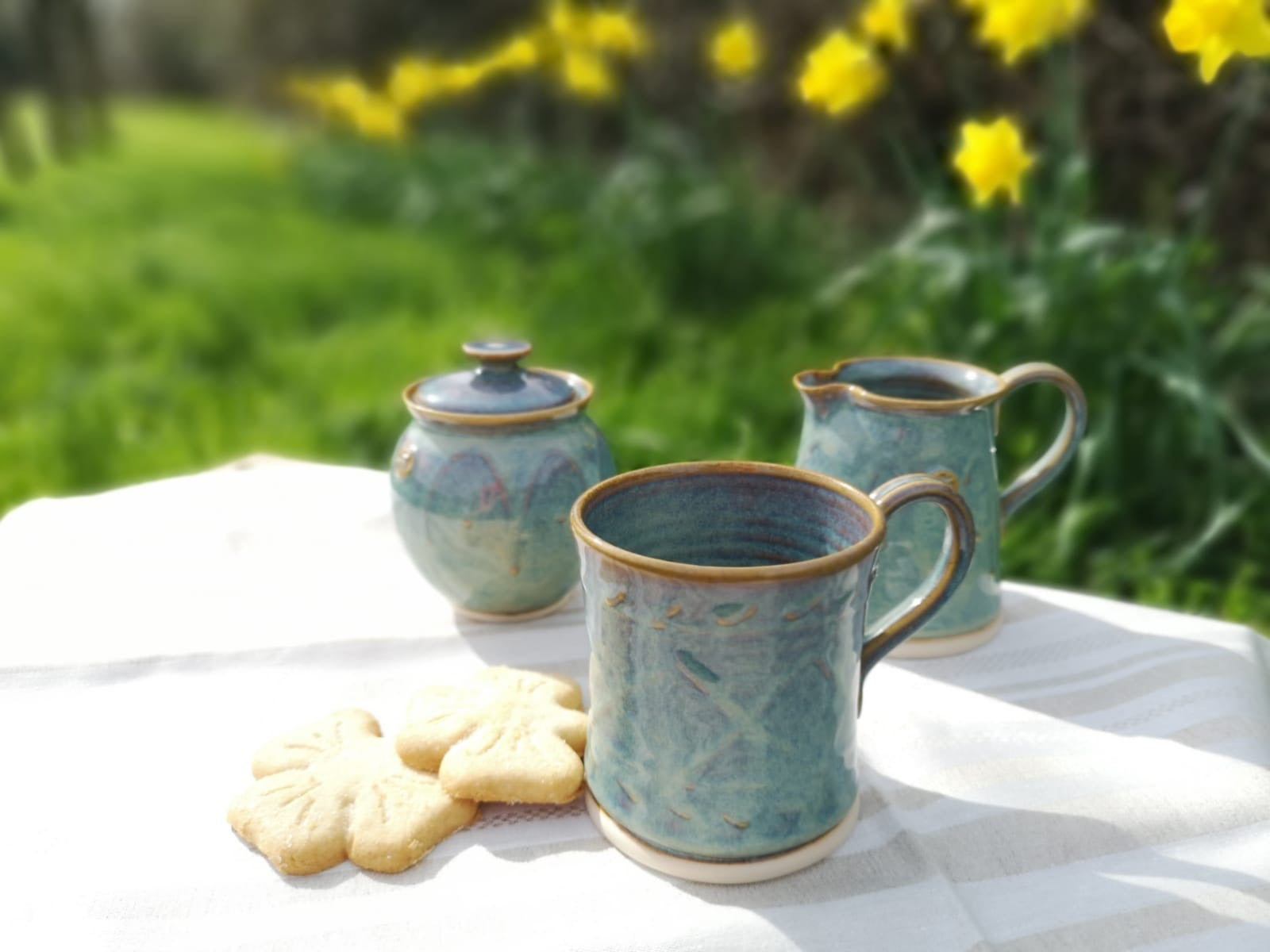 Cylinder Mug and Creamer set on outdoor table with biscuits and flowers